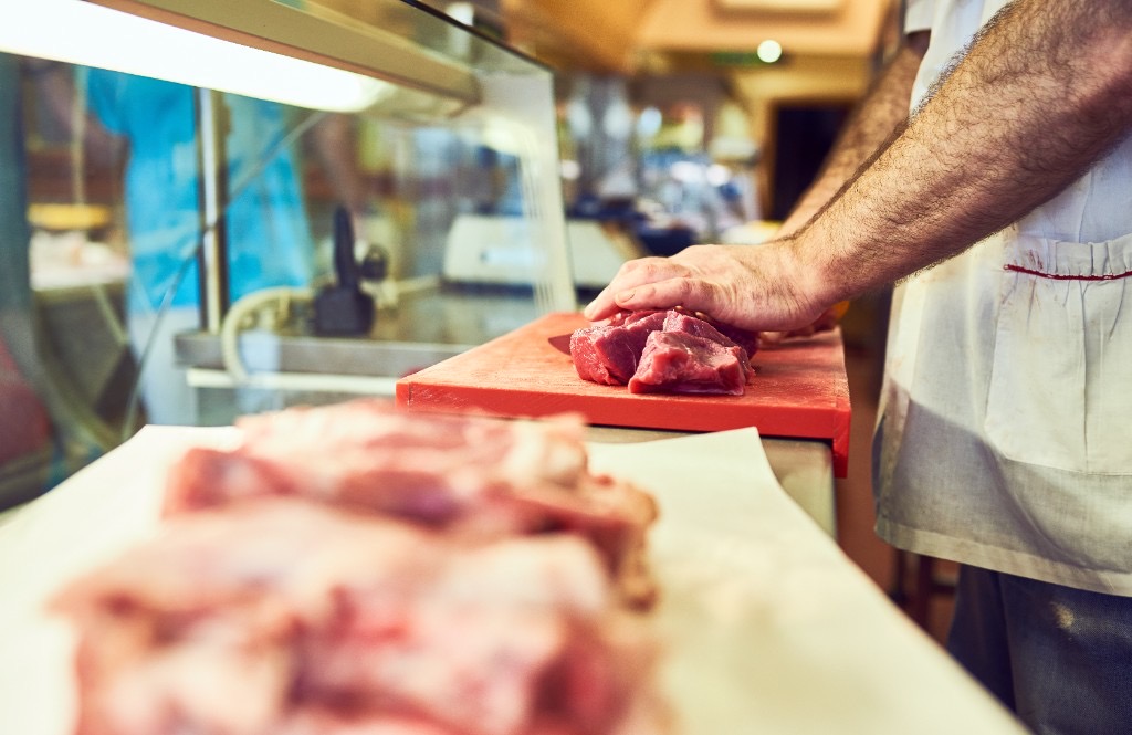 Butcher preparing fresh cuts of meat at Sudlersville Meat Locker